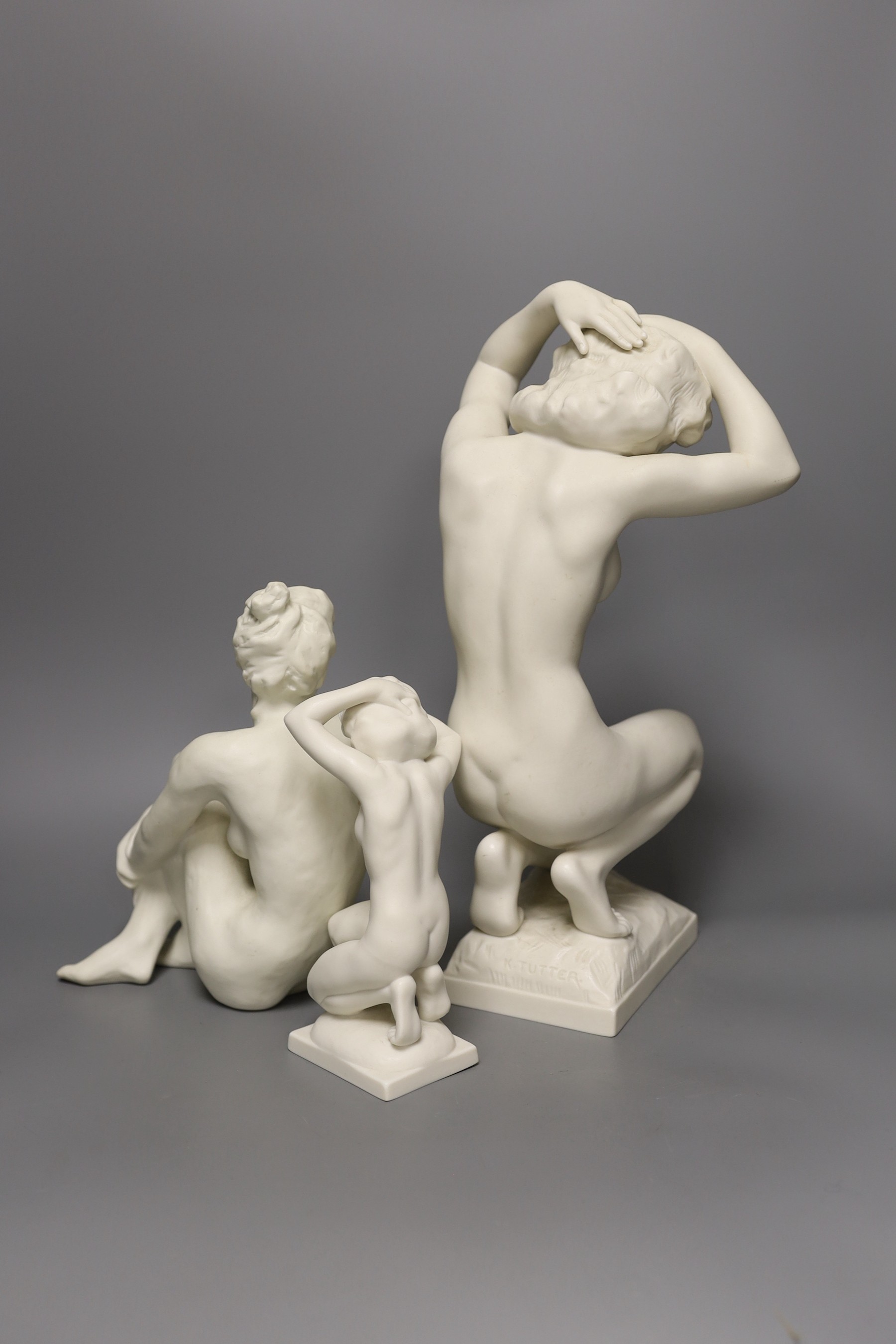 A Karl Tutter for Hutschenreuter bisque kneeling nude, a similar smaller nude and another by Rosenthal. Tallest 35cm